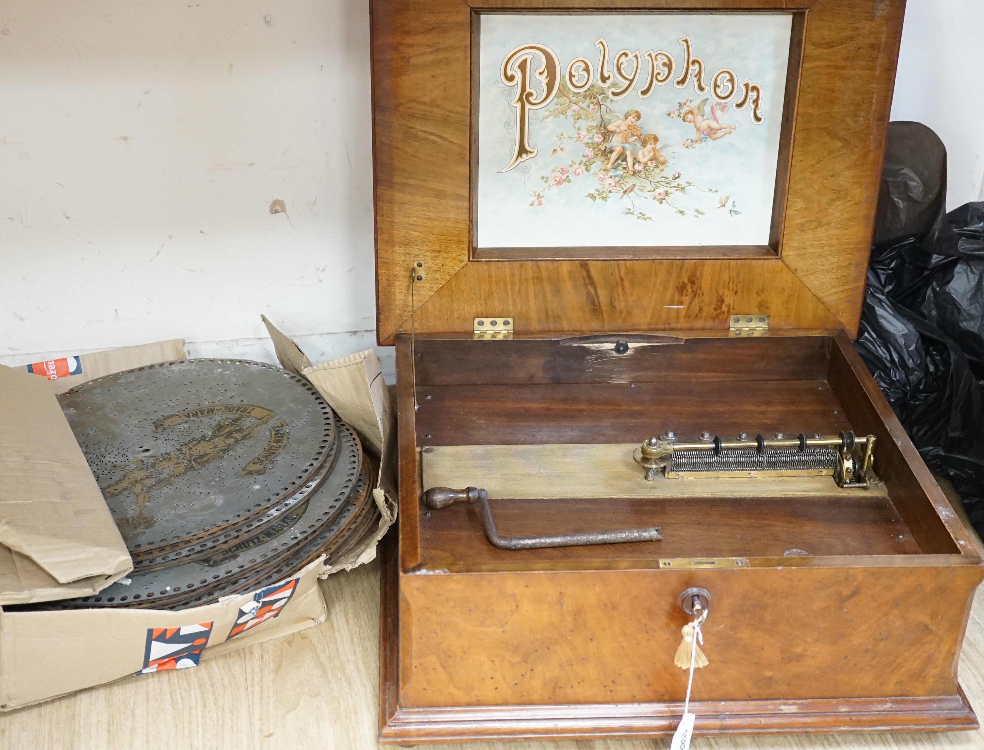 An early 20th century walnut cased polyphon and thirty discs